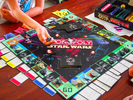 Kids Using Monopoly as a Homeschooling Resource